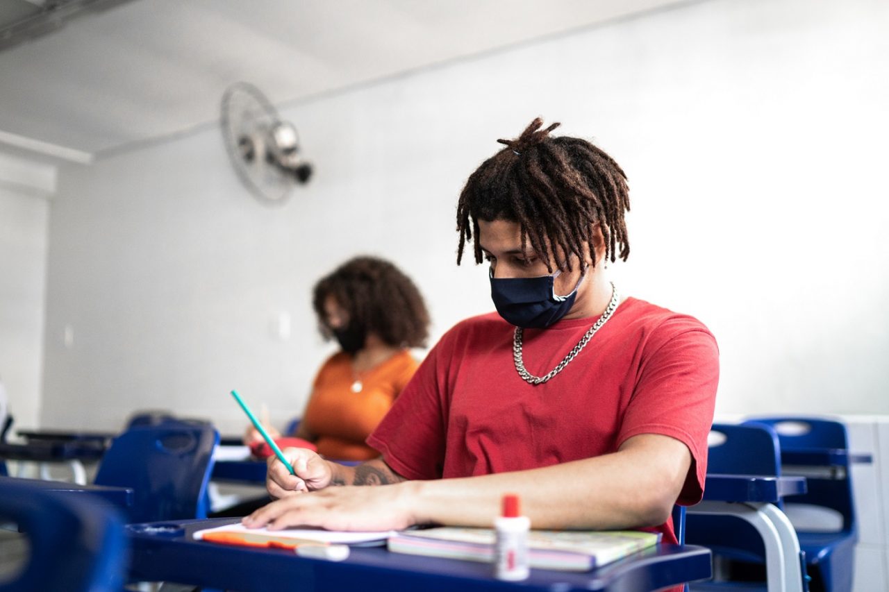 University / high school student wearing face mask while studying in the classroom