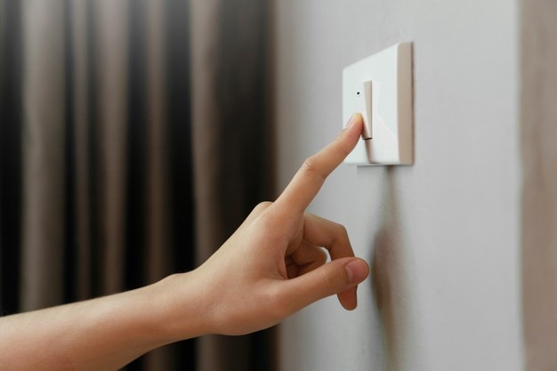 female-finger-is-turn-off-lighting-switch_40048-372