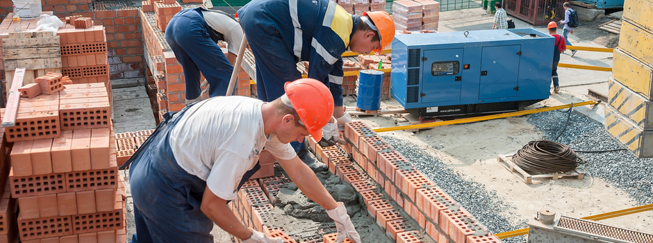 Team of bricklayers on house construction