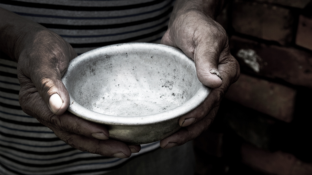 The poor old man's hands hold an empty bowl. The concept of hung